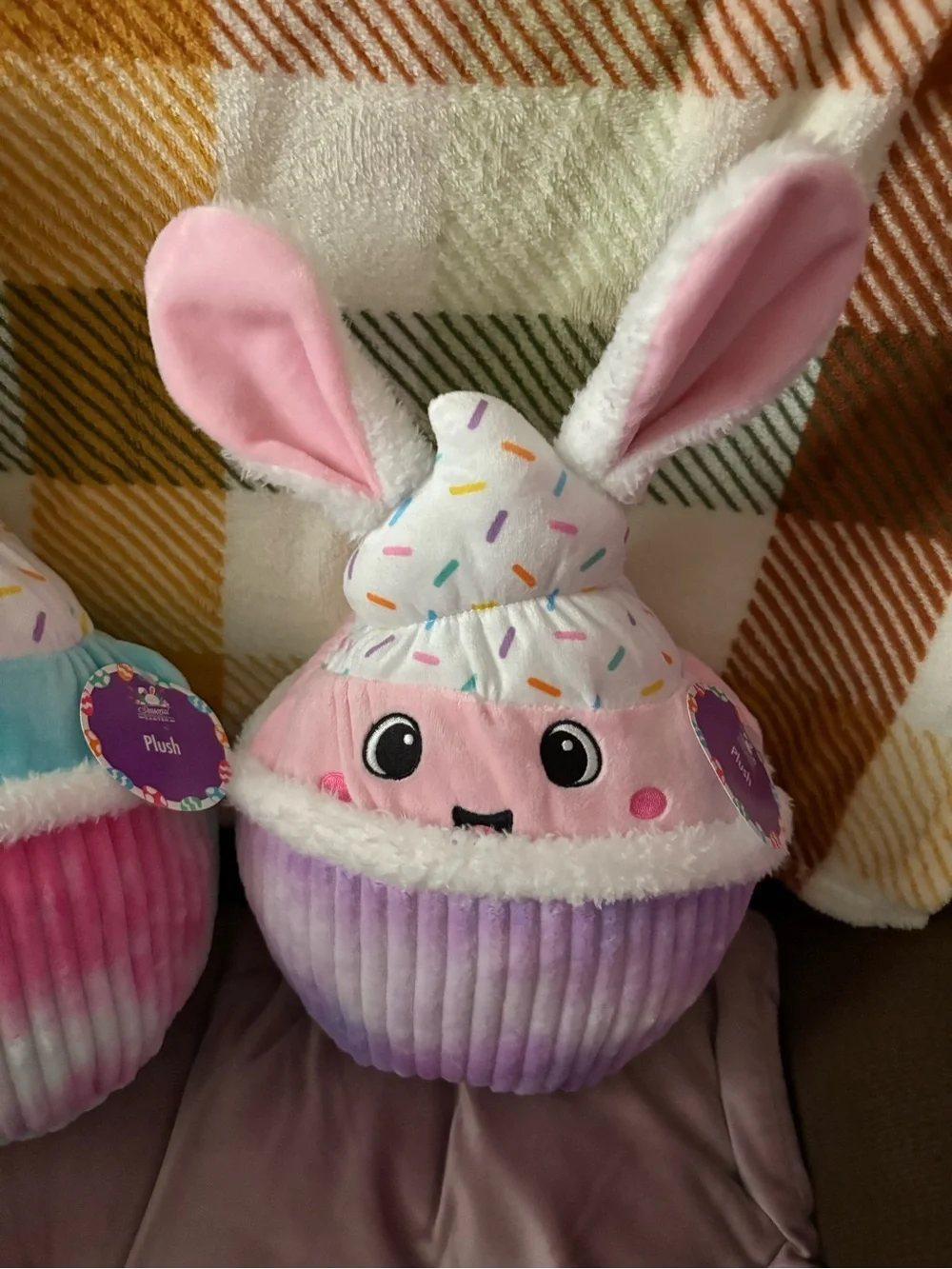 Two Plush cupcakes . 13in height 20 in round , pastel colors , multi / solid